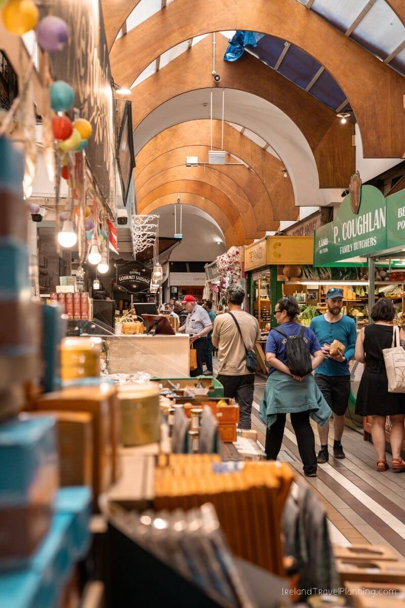 Visitors exploring Cork City Market with shops and colorful decor