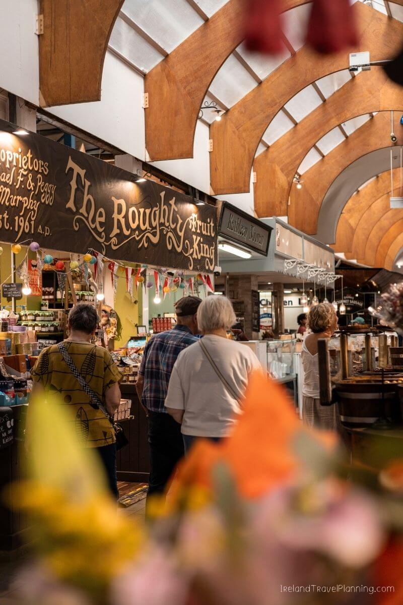 Visitors browsing at The Rough Fruit King shop in Cork City market
