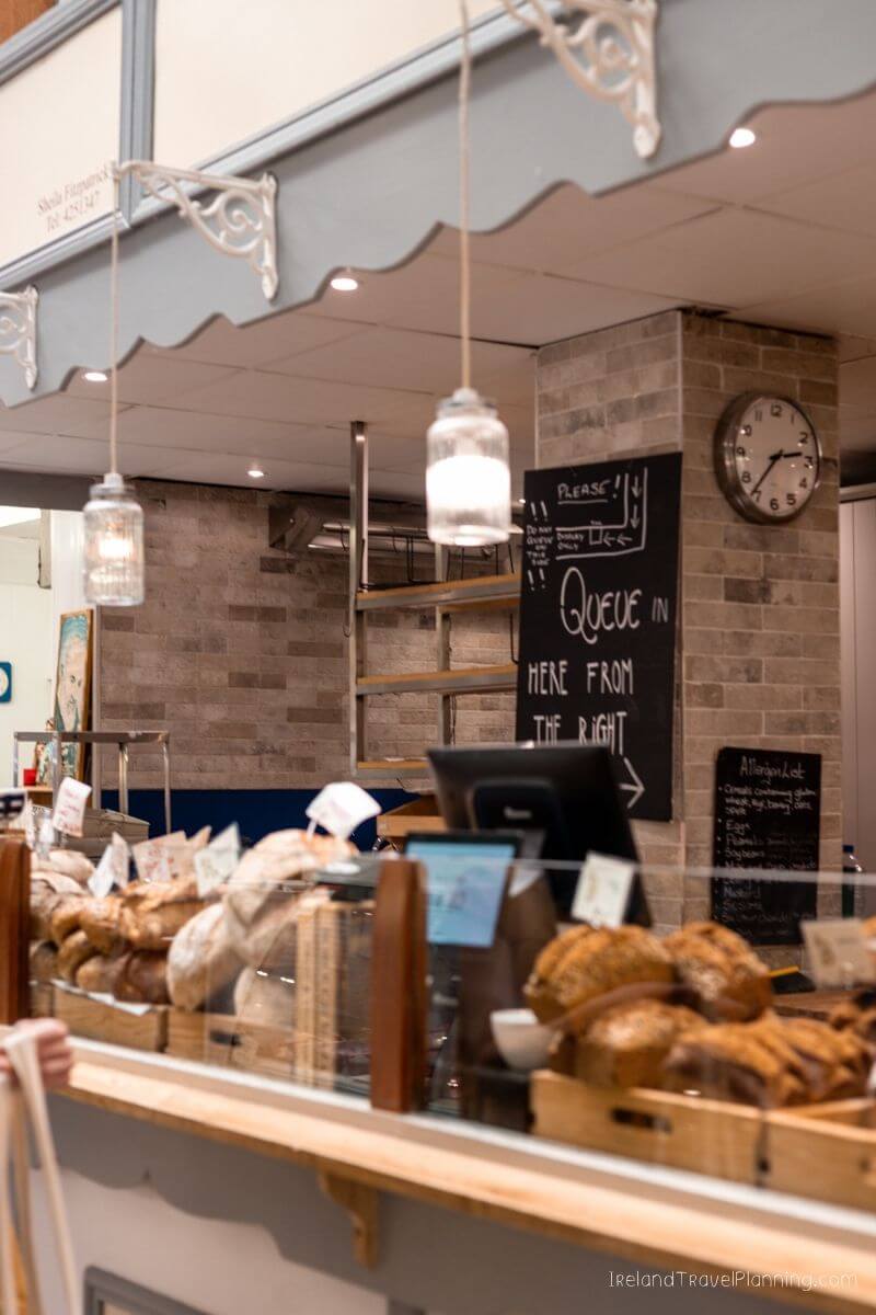 Bread counter with queue sign and baked goods in Cork City