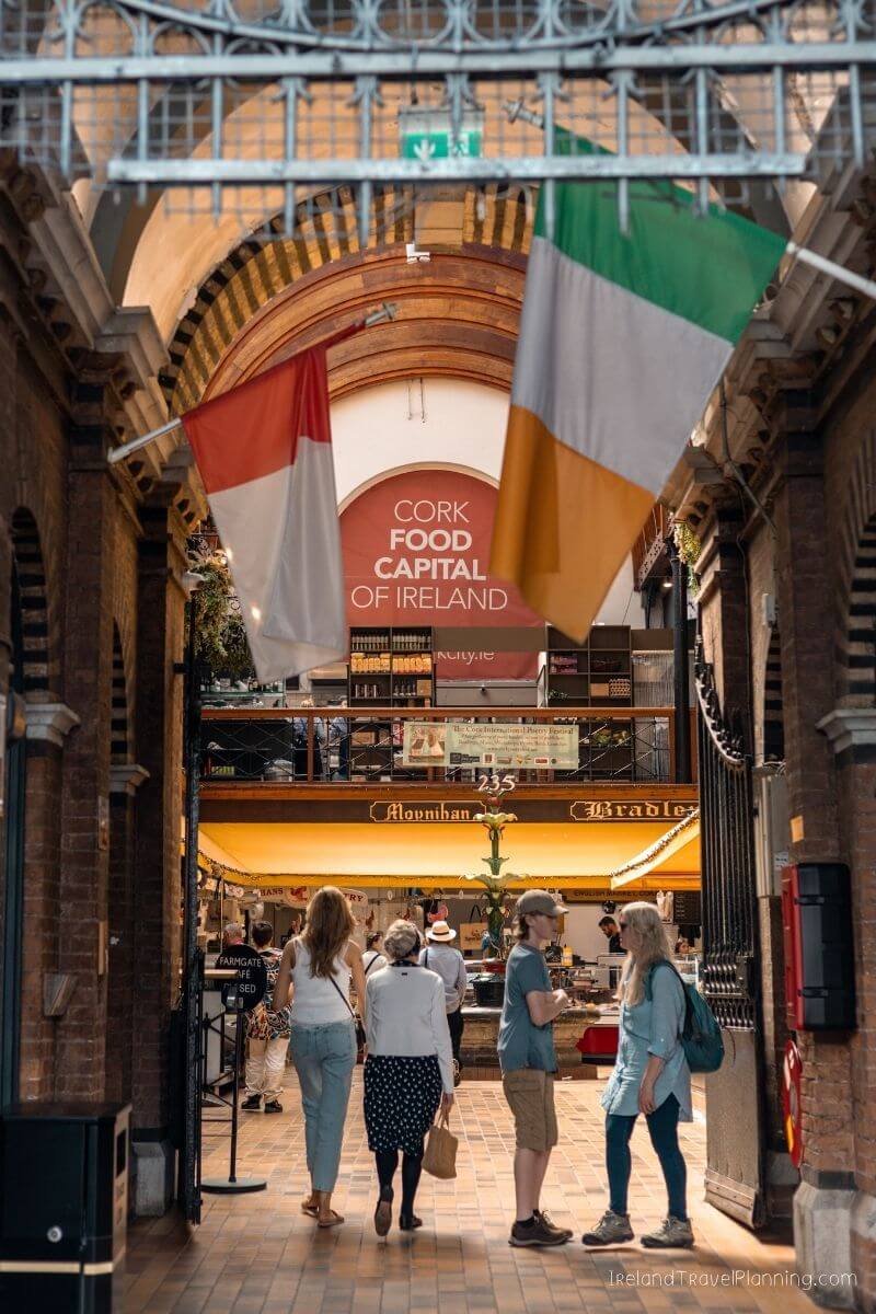 Cork Food Capital of Ireland sign above people at the English Market in Cork City.