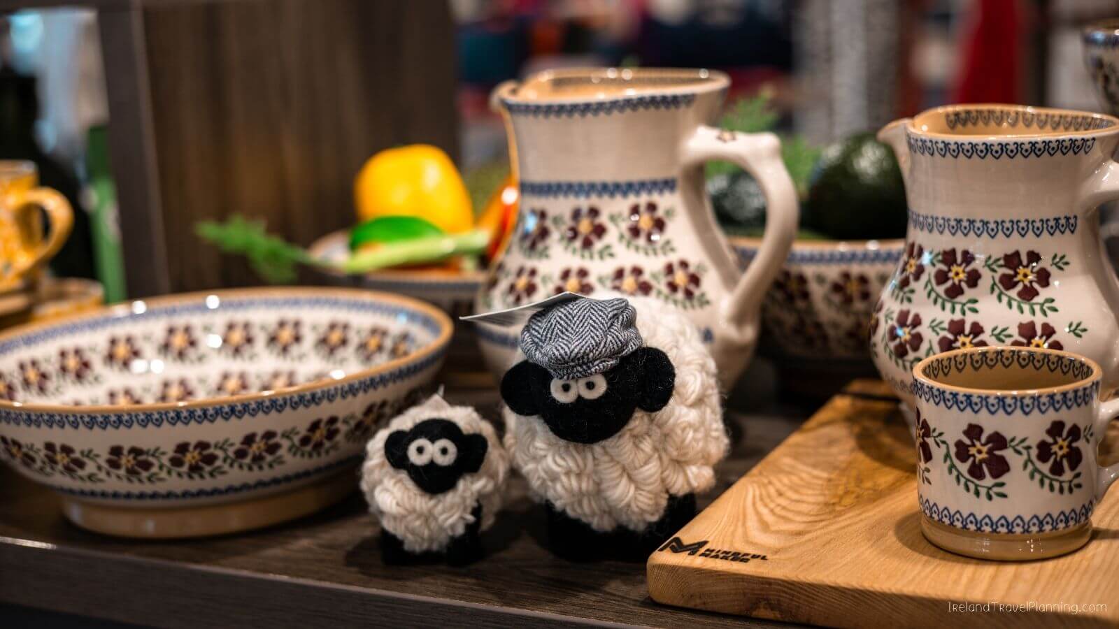 Decorative ceramic sheep figurines and dishes on a wooden table
