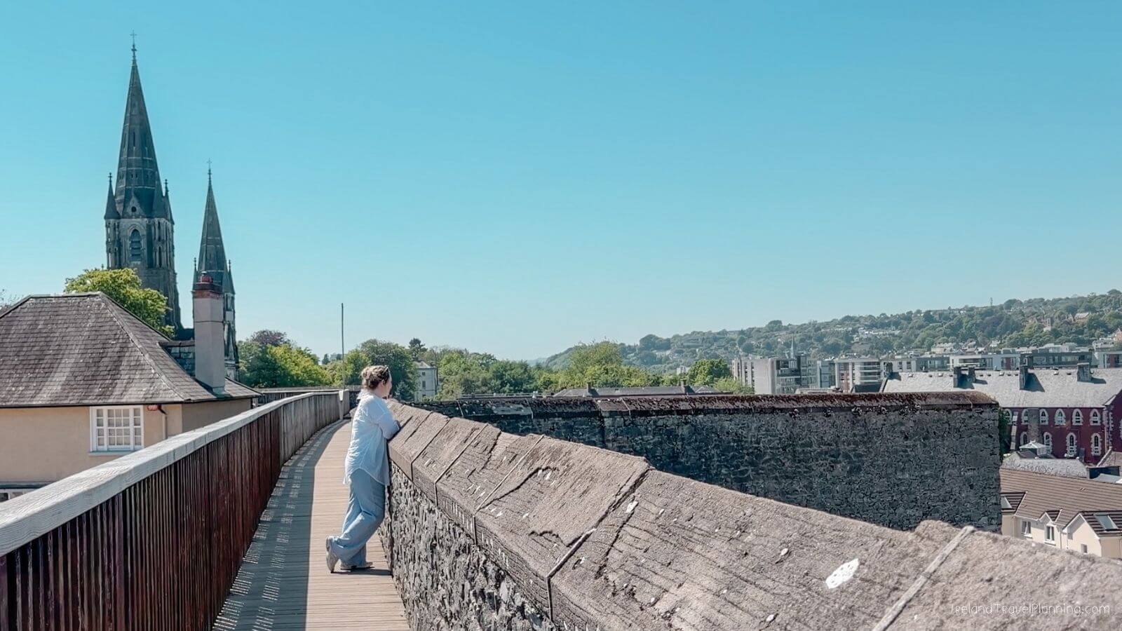 Person looking at Cork City view from a historic bridge