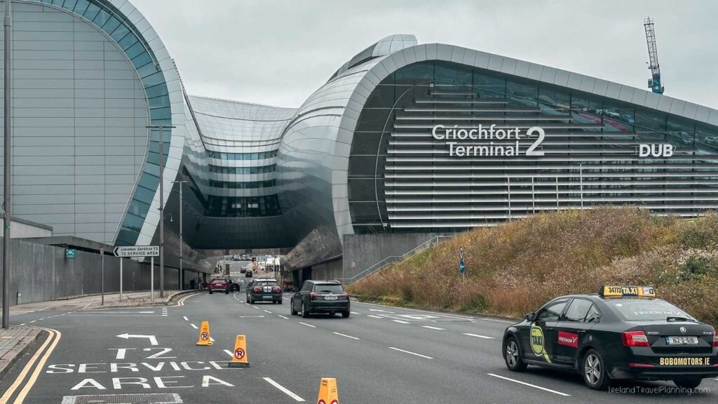 Dublin Airport Terminal 2 entrance with cars and taxis on the road