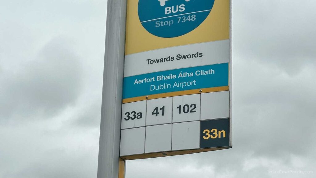 Dublin Airport bus stop sign showing routes 33a, 41, 102, and 33n towards Swords.