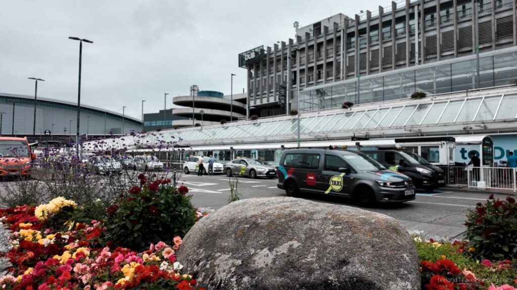 Dublin Airport DUB taxi rank with cars and flowers