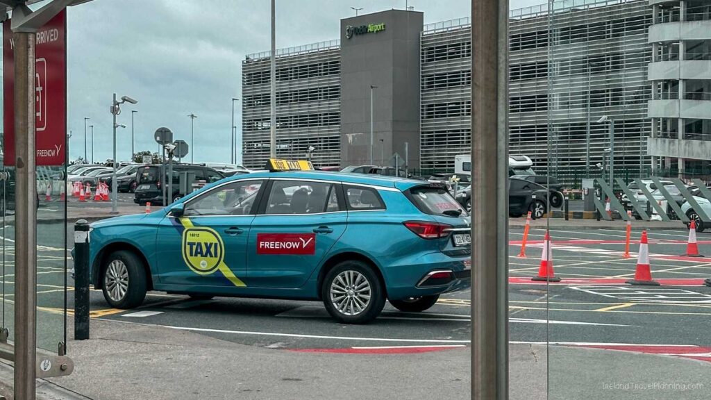 Freenow taxi at Dublin Airport with airport building in background.