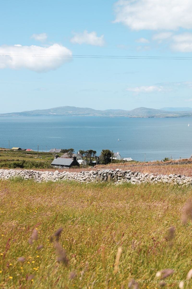 Rural Irish landscape with houses near a sea inlet on a clear day
