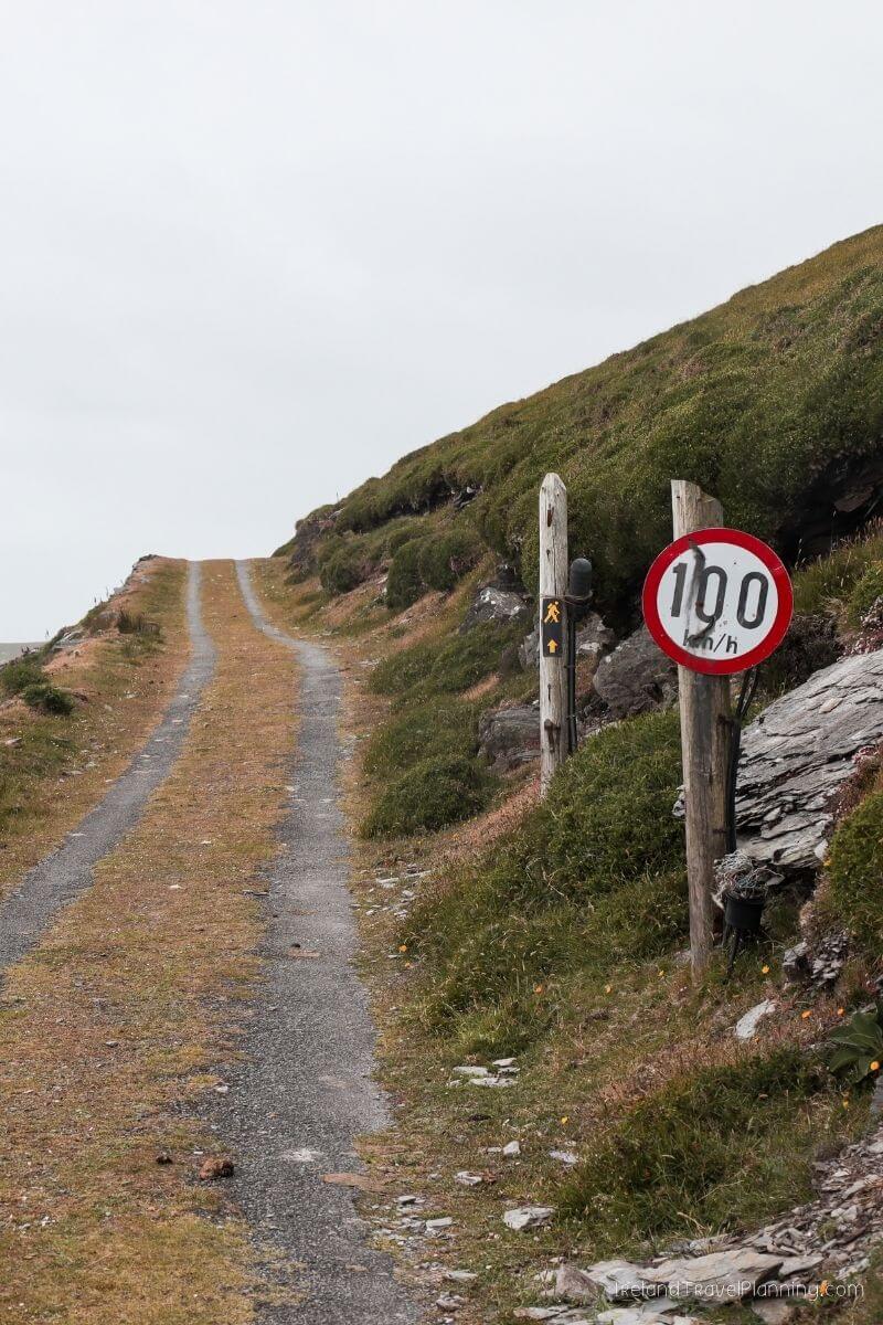 Ireland hidden gem: 100 km/h speed limit sign on a rural road leading uphill