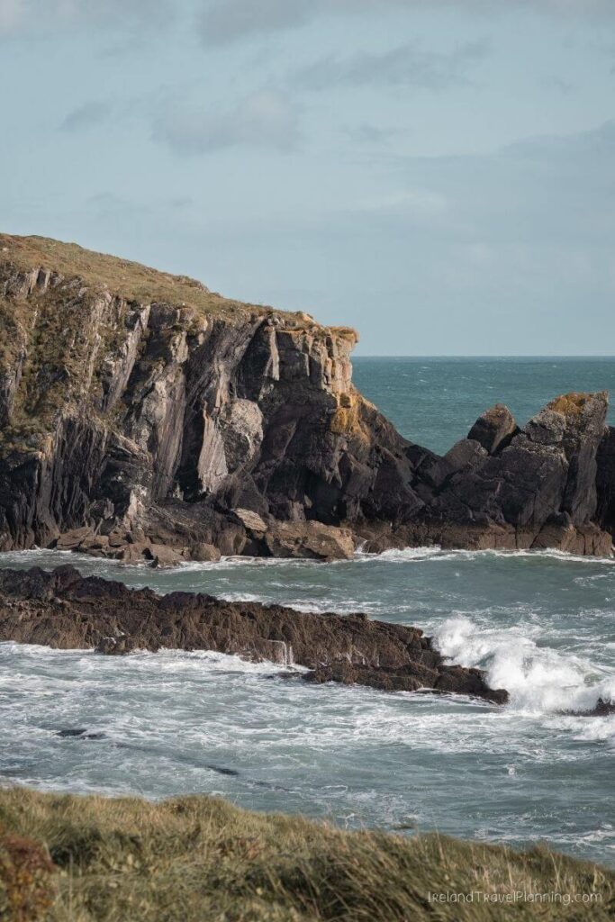 Dramatic cliffs and rocky coastline battered by waves on the Wild Atlantic Way, Ireland.