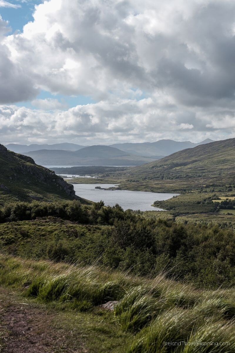Scenic lake and rolling green hills in Ireland, a hidden gem.