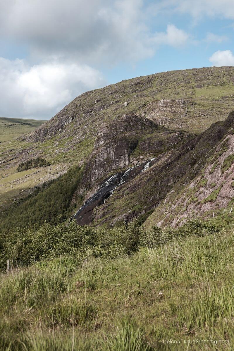 Cascading waterfall down a rocky Irish hillside, a hidden gem.