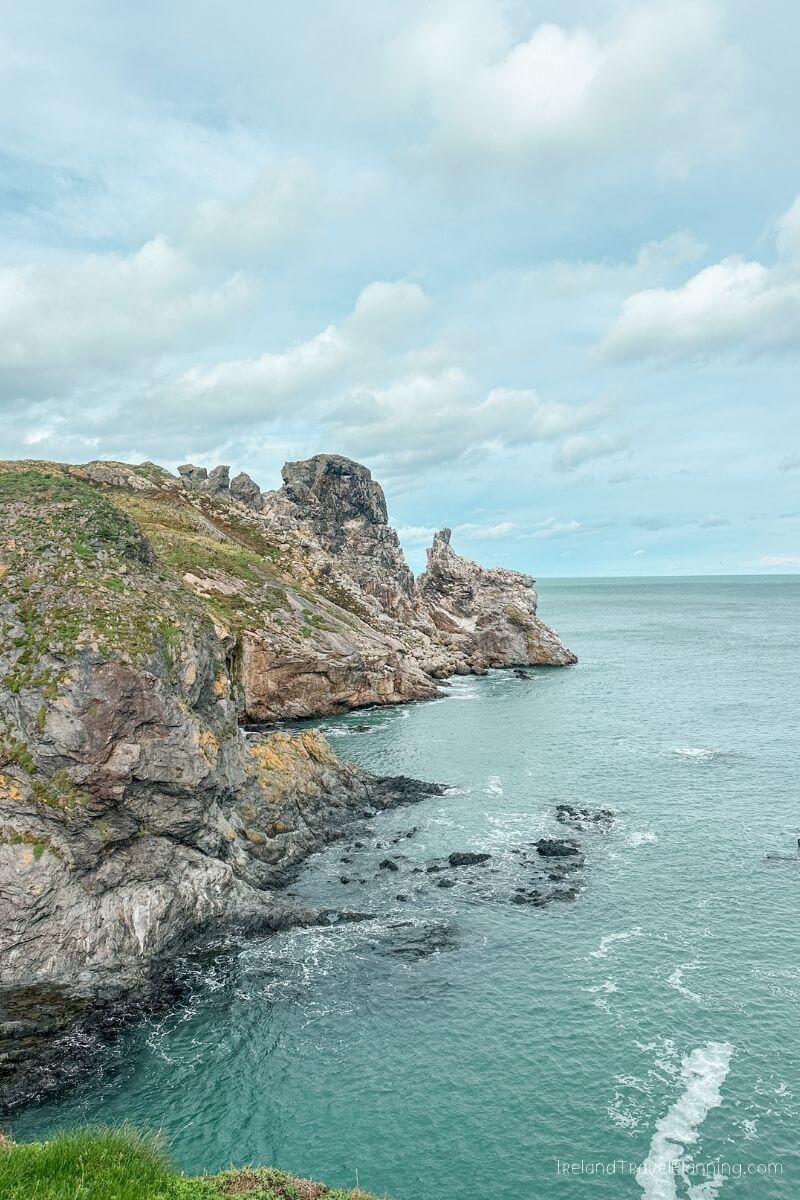 Rugged Irish coastline with dramatic cliffs and turquoise sea, a hidden gem.