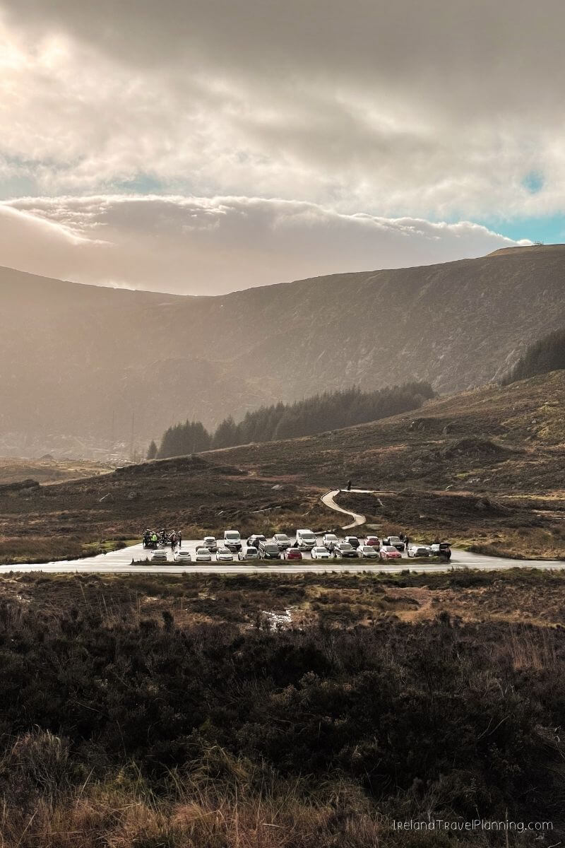 Cars parked at a scenic viewpoint in the Irish mountains, a hidden gem.