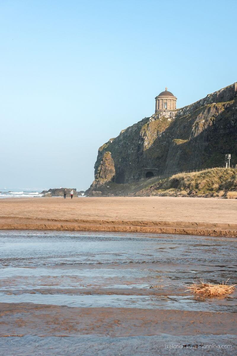 Mussenden Temple on a cliff overlooking a beach in Ireland