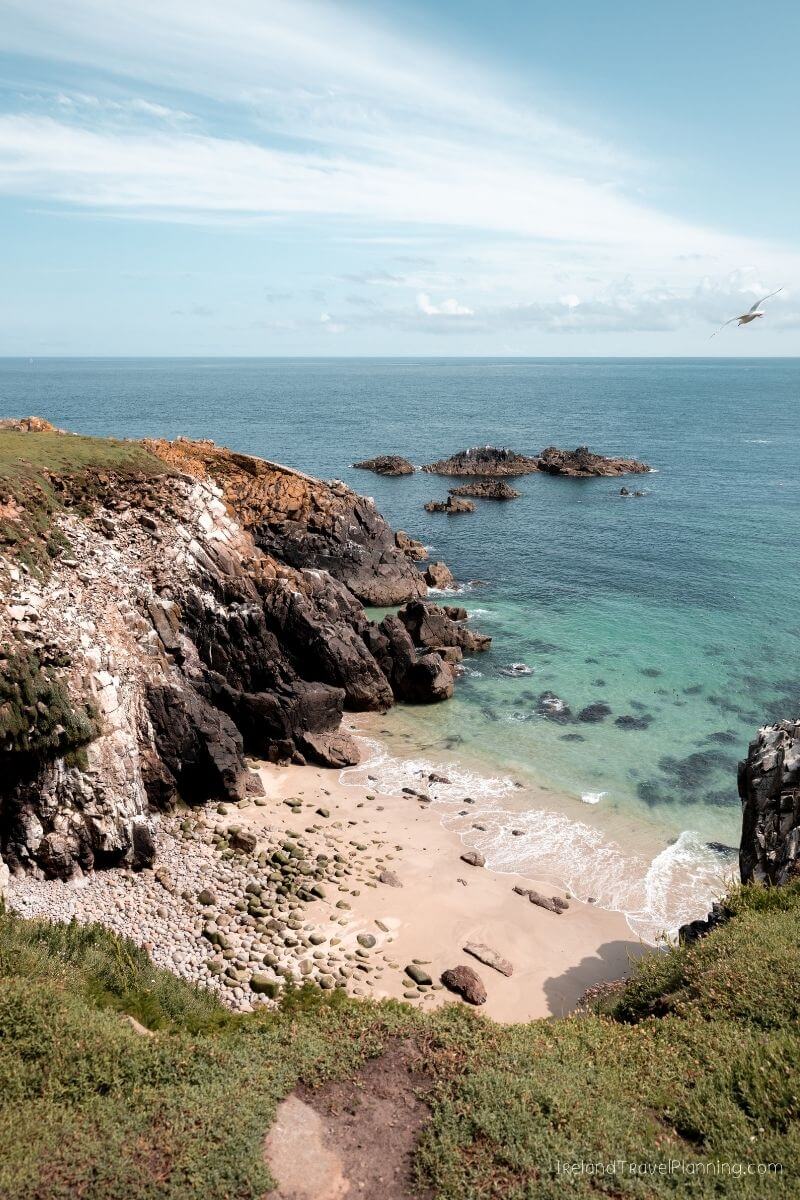 Hidden gem: Secluded Irish cove with rocky cliffs and clear turquoise water