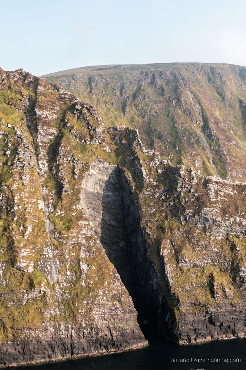 Dramatic sea cliff with a deep fissure, a hidden gem in Ireland.