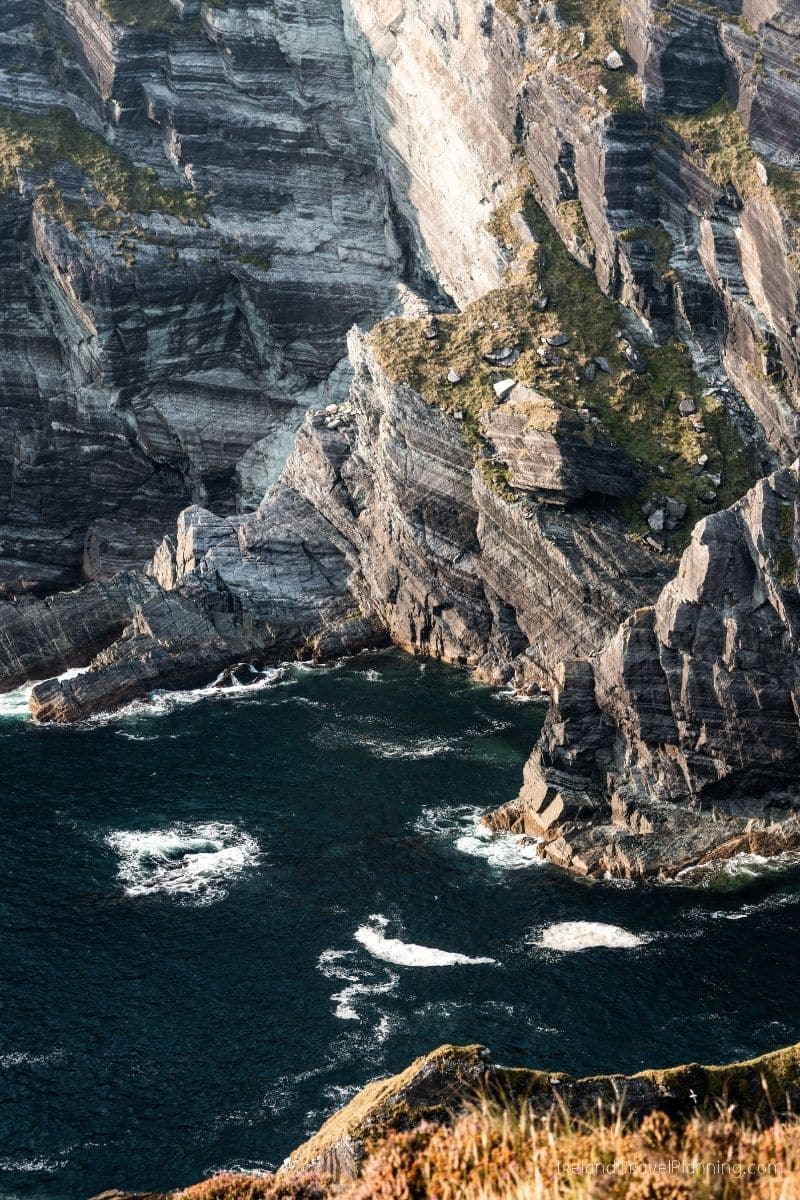 Rugged cliffs and dark ocean waves at a hidden gem in Ireland.