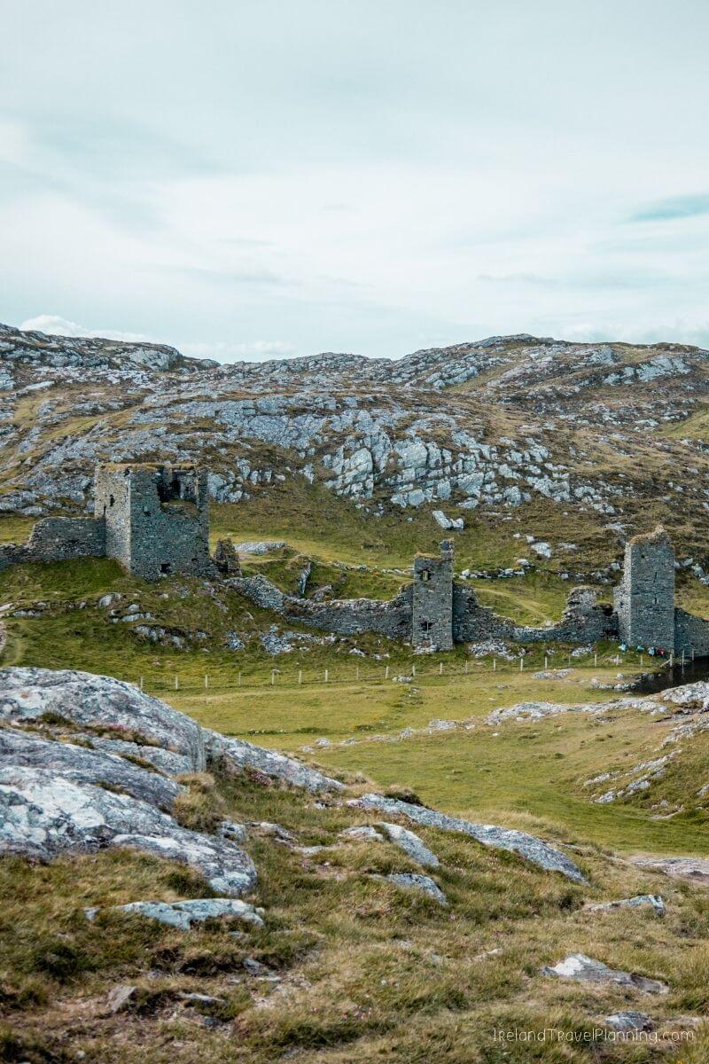 Ancient stone castle ruins nestled in a green Irish landscape