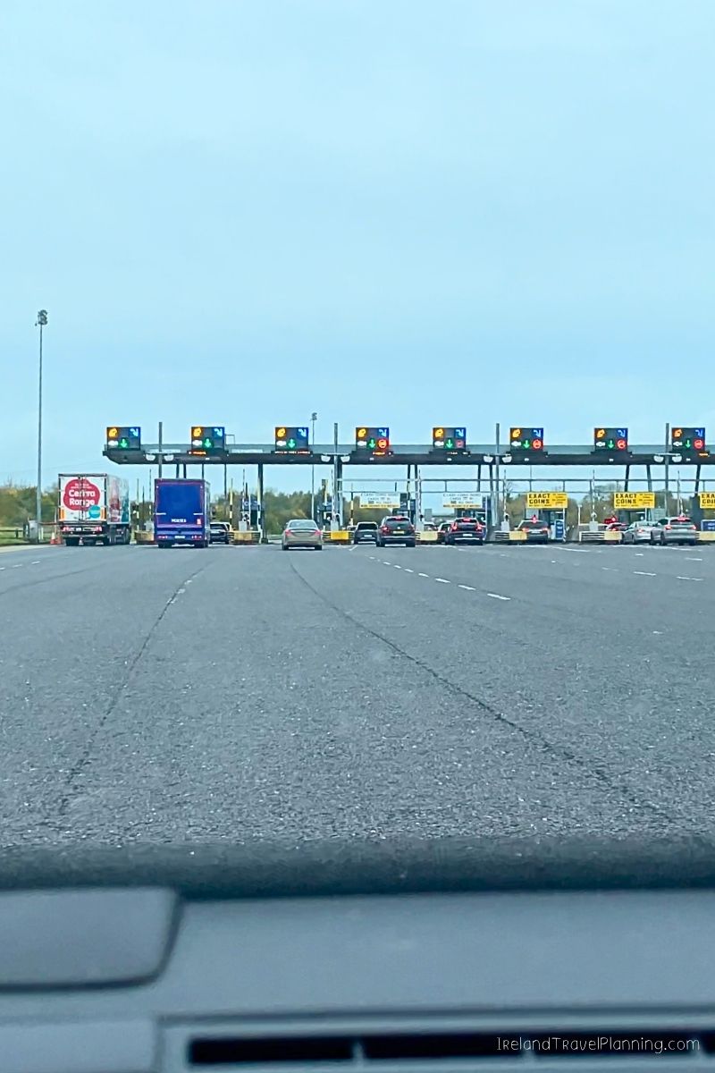 Toll plaza in Ireland with cars and trucks, relevant to renting a car in Ireland.