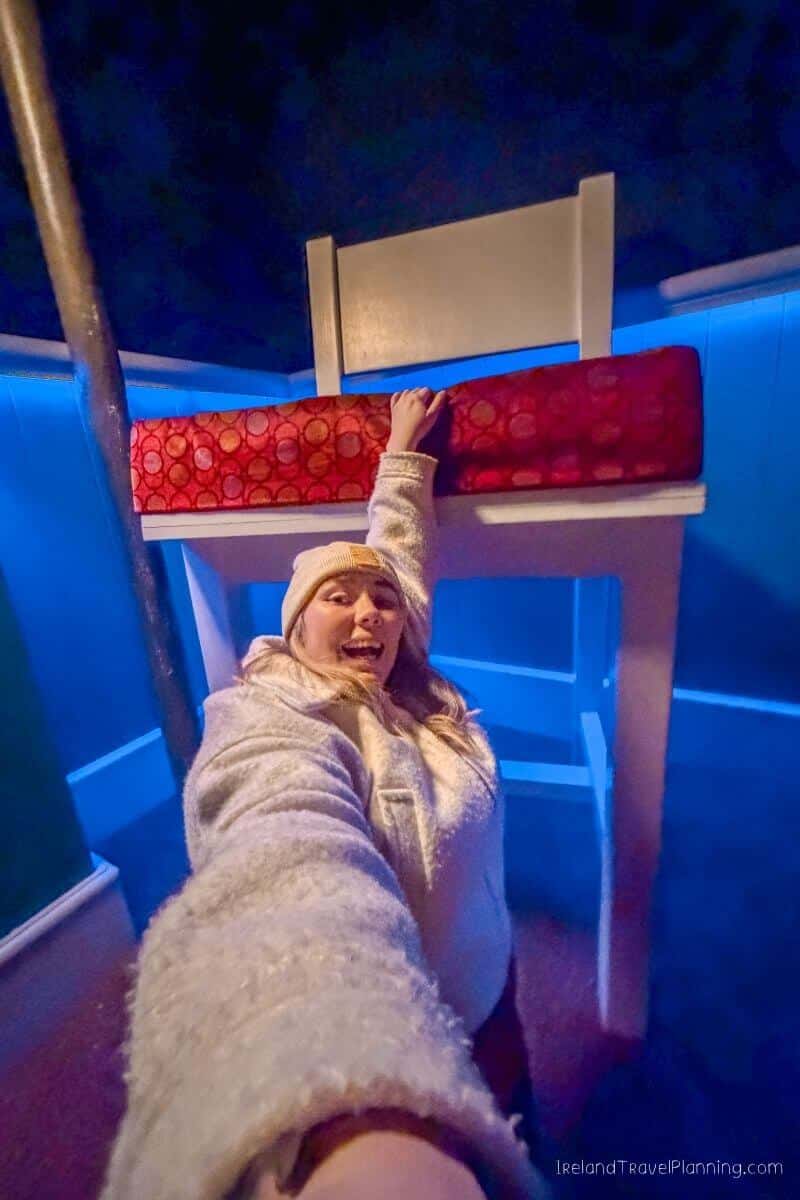 Woman hanging from a chair in a room with blue walls