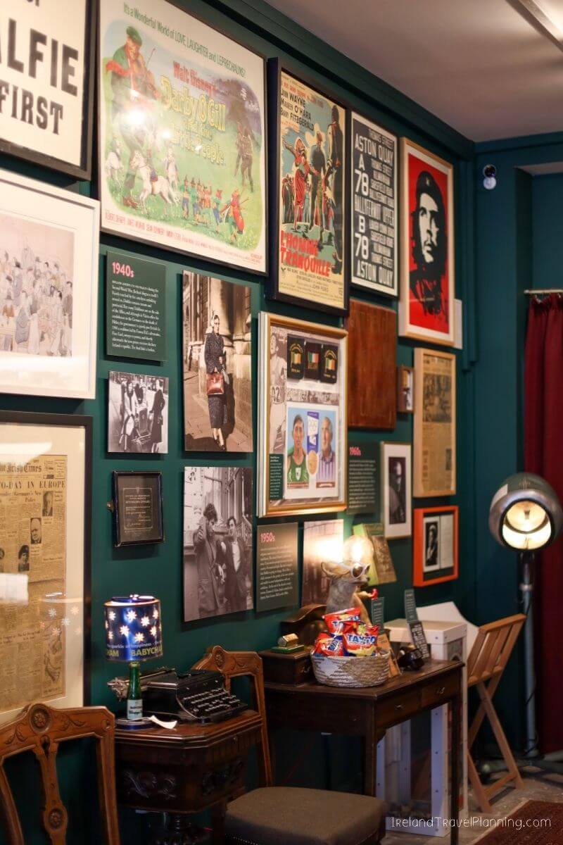 Vintage movie posters and memorabilia displayed on a dark green wall.