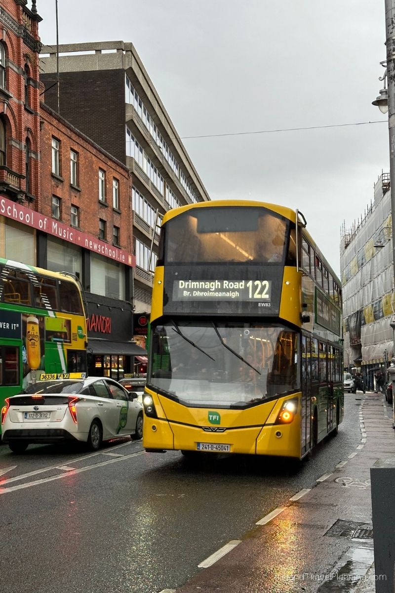Yellow Dublin bus on a wet street, route 122 to Drimnagh Road