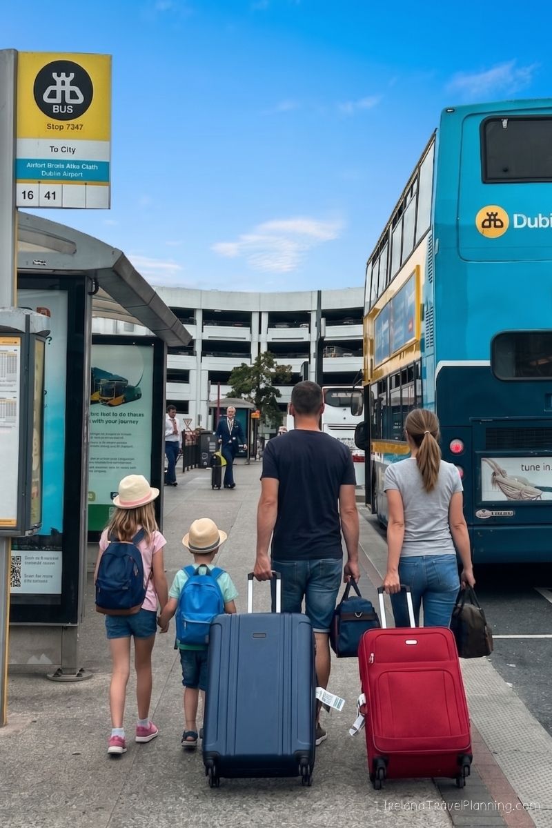 Family with luggage at Dublin Airport bus stop, Ireland trip planning
