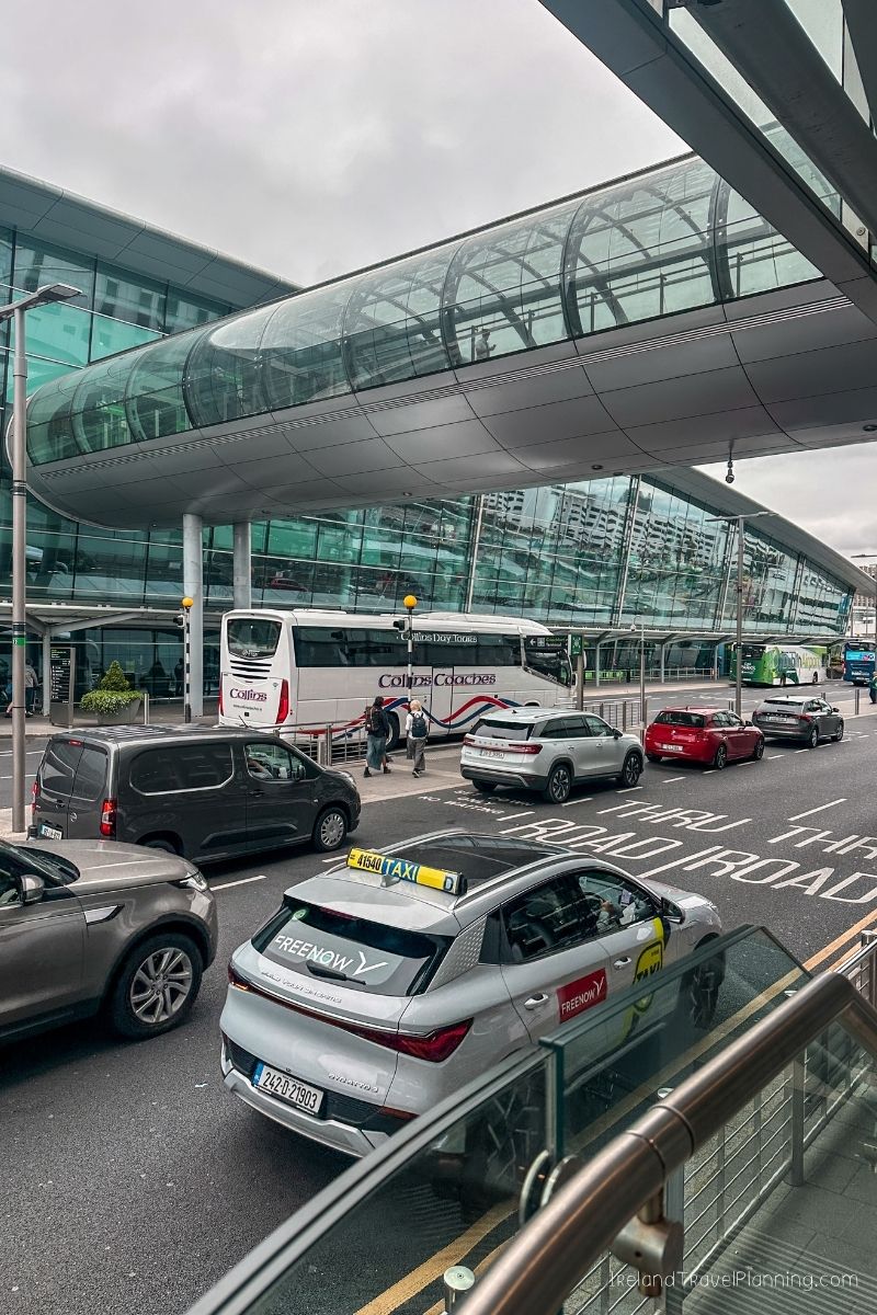 Dublin Airport taxi rank with a bus and cars
