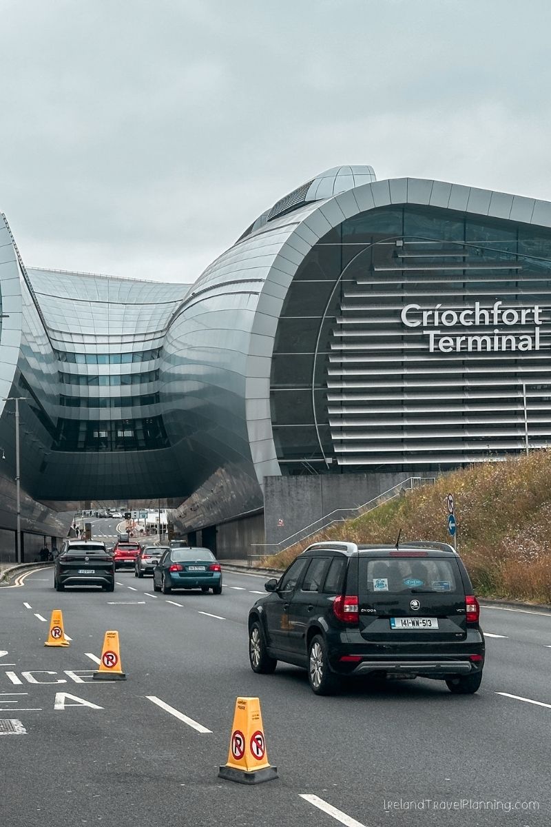 Dublin Airport's Terminal 1, Criochfort, with cars driving on the road.