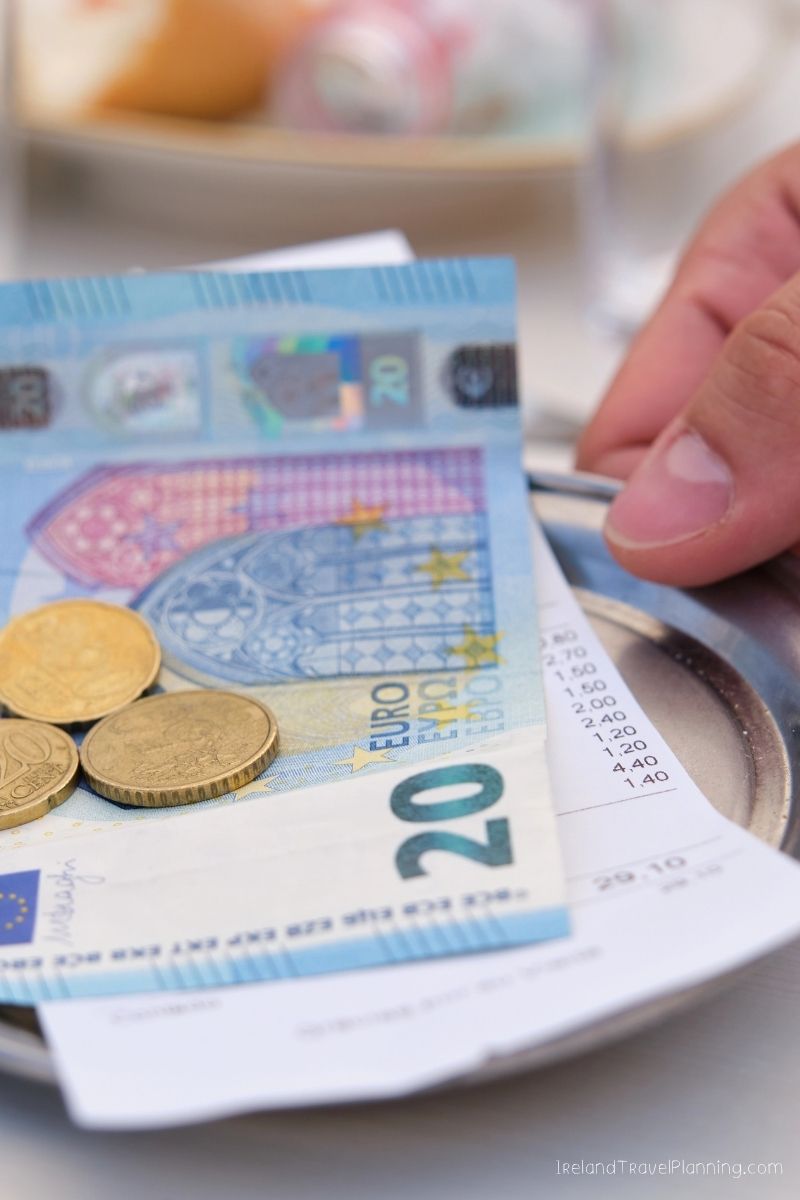 20 Euro bill and coins on a restaurant bill in Ireland
