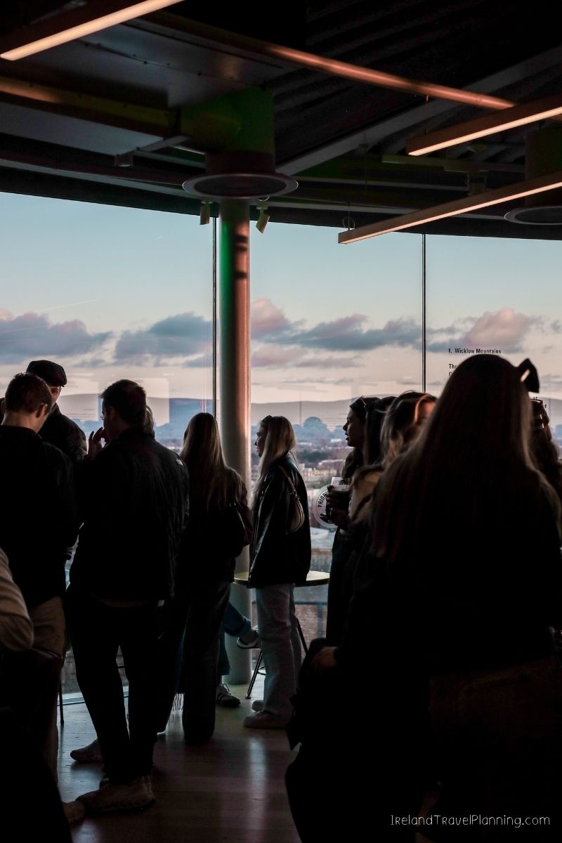 People enjoying a view of the Wicklow Mountains from a rooftop bar in Ireland.