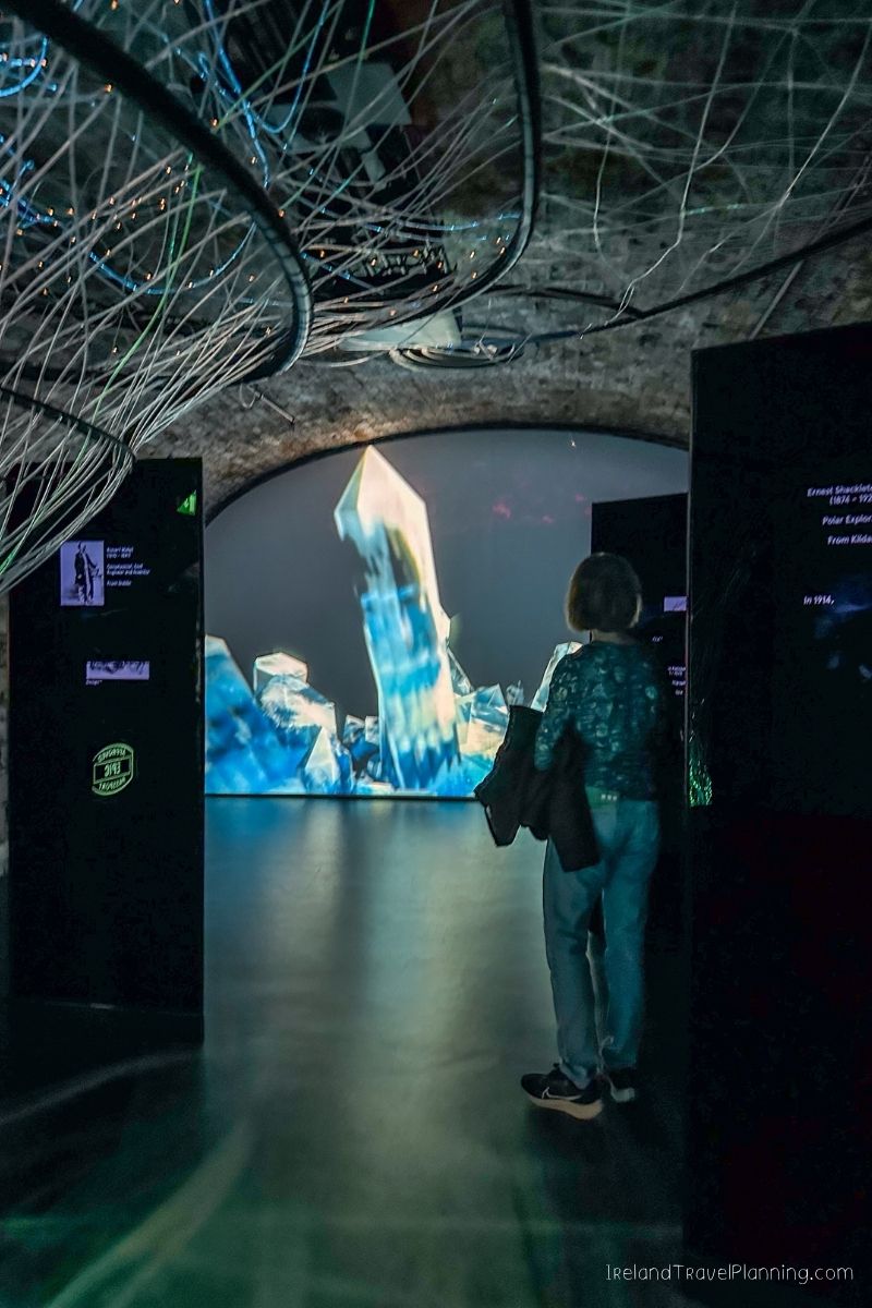 Visitor at an Ireland exhibition viewing a crystal projection