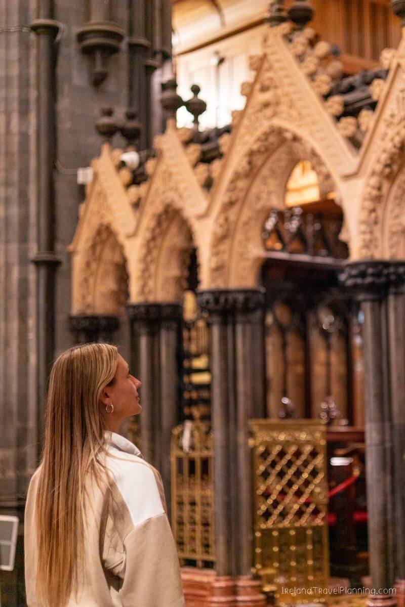 Woman admiring ornate Gothic architecture in Ireland