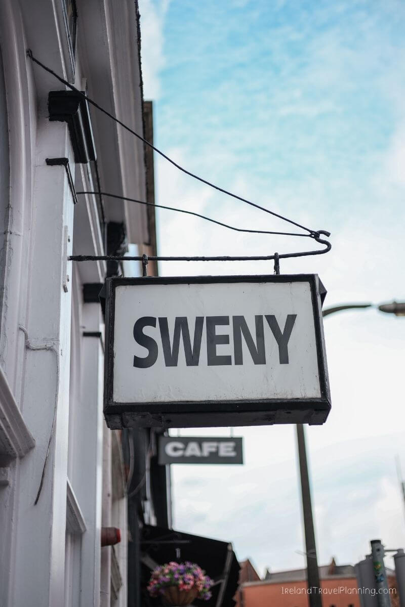 Sweny Cafe sign hanging outside a building