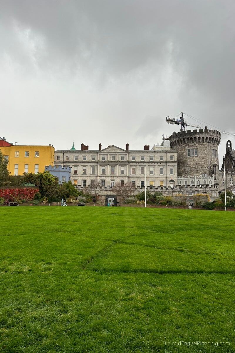 Dublin Castle and park with colorful buildings and cloudy sky