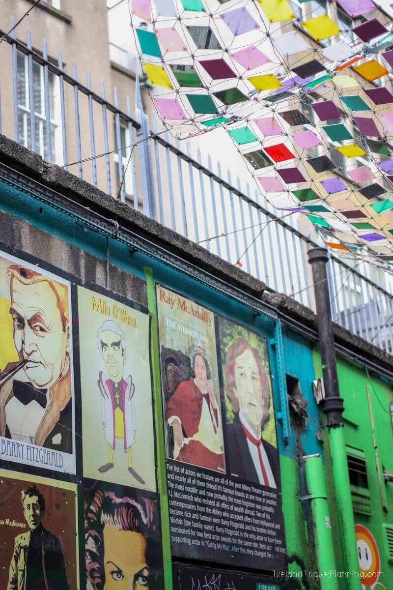 Posters of actors Milo O'Shea and Barry Fitzgerald on a colorful building in Ireland